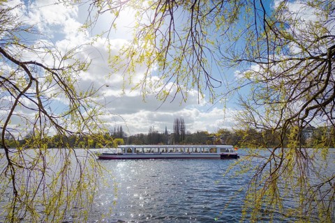 Feeling with an Alster steamer as a tourist ship on the Outer Alster in Hamburg