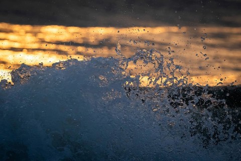 Detail, splashing seawater, breaking wave in evening light, Houvig Beach, North Sea, Denmark