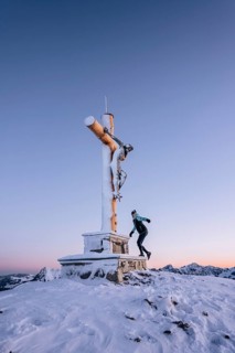 Summit bliss in the snow-covered winter landscape in the Tannheimer Tal in the Alps on the