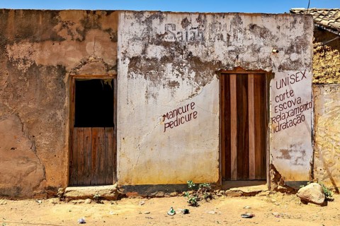 Old building with weathered walls and lettering that exudes a rural atmosphere, houses in a village