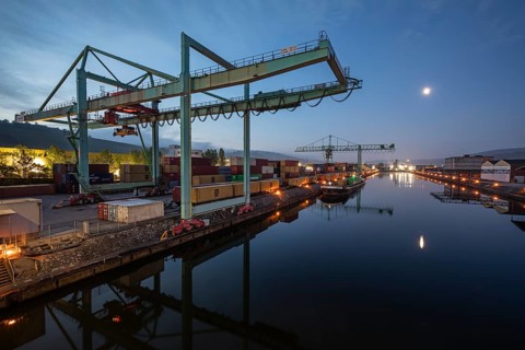8.5.2026: Container terminal at Stuttgart harbor with cranes and barge under moonlight. Stuttgart,