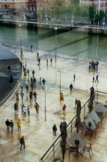 View of a crowd of people with window reflection and movement