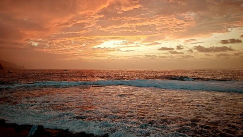Dramatic sunset over the sea with intense shades of orange and red, Santo Antao, Cabo Verde, Cape