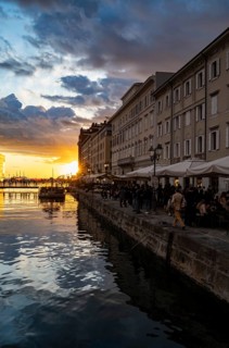 Grand Canal with restaurants, reflection in the canal, sunlight, evening light at sunset, dramatic