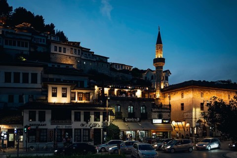 BERAT, ALBANIA - JULY 2, 2026: Illuminated streets and traditional Ottoman buildings at night with