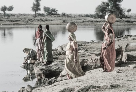 Women carry stuffed water balls on their heads at Gadsisar Lake, Jaisalmer, Rajastan, India