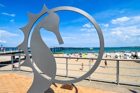 Seahorse figurine, landmark of Timmendorfer Strand, on the pier forecourt at the Maritim pier,