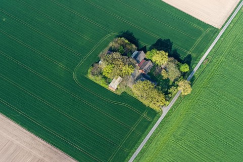 Aerial view of a small farm in the district of Vechta surrounding agricultural land, fields,
