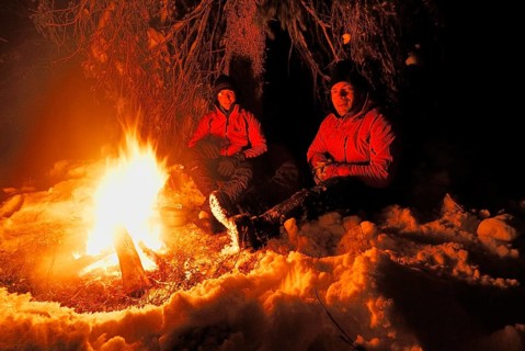 Two men around a campfire at night, Muddus National Park, Laponia World Heritage Site, Lapland,