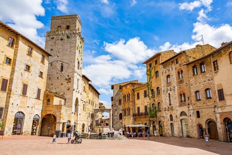 Towers of the old Town with historic buildings from Piazza della Cisterna at San Gimignano on a