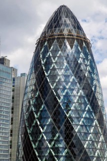 Norman Foster's lattice glass tower at 30 St Mary Axe, nicknamed The Gherkin, rises above the City