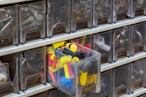 Opened plastic parts drawers showing twist on yellow, black, blue and red electrical wire