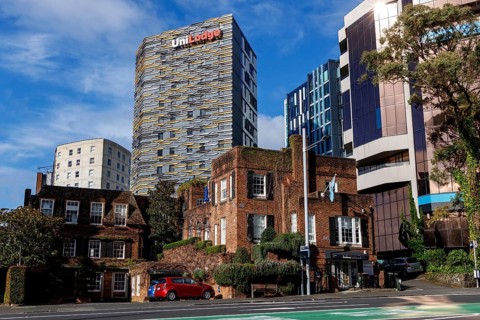 Historic Brickhouse Bar and Restaurant with UniLodge tower and modern buildings behind, Auckland