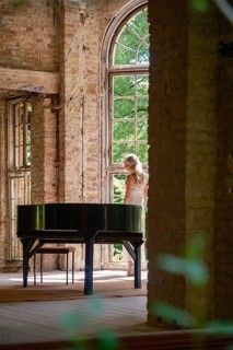 A woman stands at the wing in the former Grabowsee health resort, Lost Place, Oberhavel,