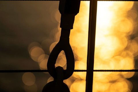 Part of the rigging of a sailing ship, anchoring, steel cable, back light, sunset, silhouette,