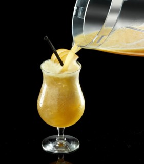 Orange-colored cocktail is poured onto ice cube cubes, against a black background, apple slices and