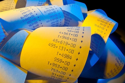 The calculation strip of a pocket calculator has calculated expenditure and profit, studio