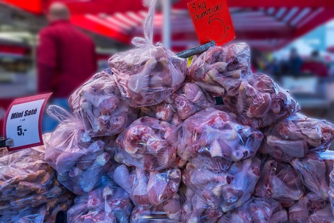 Chicken thighs packed in plastic bags, market day in Enschede, the Netherlands
