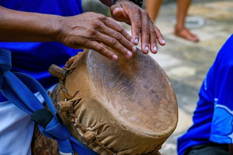 Drummer playing a rustic and rudimentary atabaque during tambor de crioula cultural manifestation,