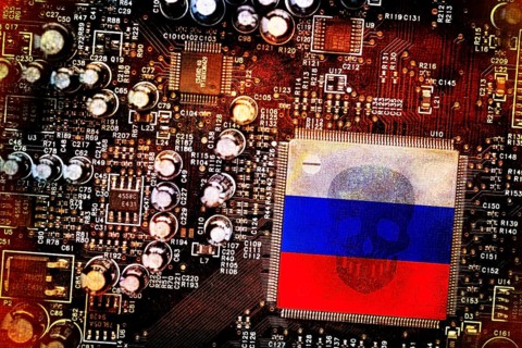 Russian flag on computer board with skull, symbolic photo of Russian cyber attacks, photo montage