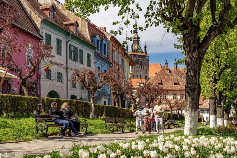 Spring in the Citadel Park and the colorful houses of the old town of Sighisoara or Sighi?oara,