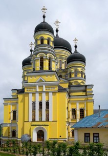 Large Orthodox church with impressive yellow façade and several domes, Hîncu monastery, Hâncu,
