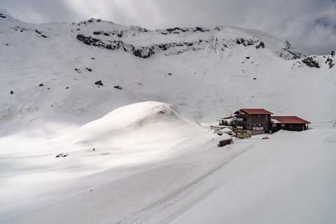 Mountain hut on snowy Balea Lake in the Fagaras Mountains, South Carpathians, Transylvania, Romania