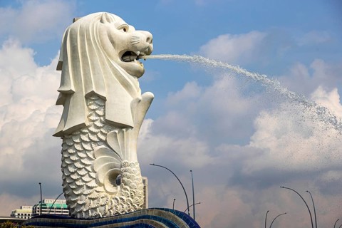 Iconic Merlion fountain spouting water designed with a lion head and fish body at Merlion Park