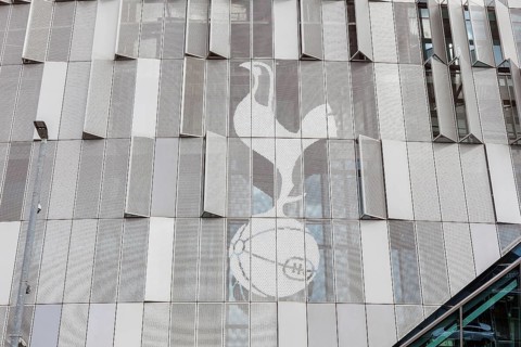 The club's cockerel emblem appears etched across the metallic cladding panels of Tottenham Hotspur