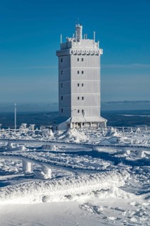 Weather station tower covered by snow and ice on the Brocken summit, on a sunny winter day under