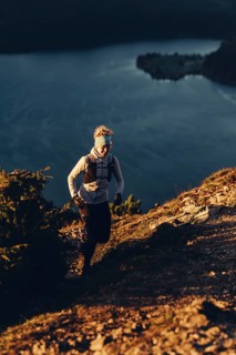 Trail running in autumn on the Jochberg on Lake Walchensee against the wonderful backdrop of the