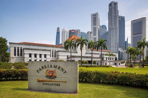 Granite Parliament Singapore marker stands before the grey facade of the legislature building and