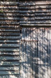Wooden hut with shadows from trees, Germany