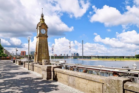 Düsseldorf, Germany - June 9th 2026: Historic Pegeluhr water level clock on the Rhine promenade