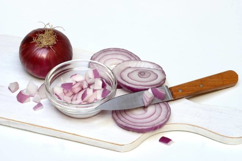 Sliced red onion with knife, Allium cepa