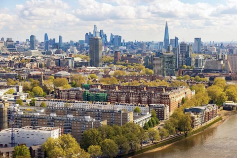 Riverside apartment blocks and the distant City skyline unfold in this aerial view from Battersea's