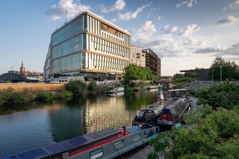 Houseboats moored, office and commercial buildings, Regent's Canal Towpath, Camden Town, London,
