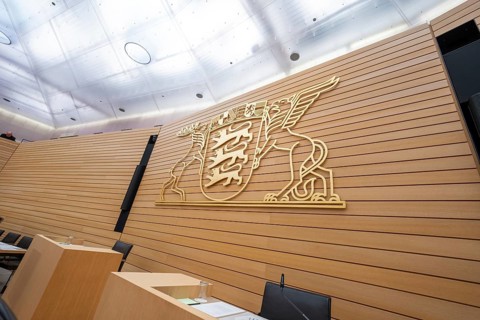 Spacious meeting room with a wooden coat of arms of Baden-Württemberg on the wall, Parliament of