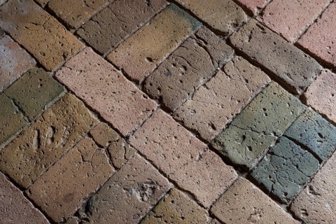 Detailed view, floor with old earth-colored bricks crisscrossed by cracks, church, Husby Church,