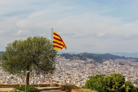 Catalan flag flies over the Montjuic Castle old military fortress on Montjuic Mountain overlooking