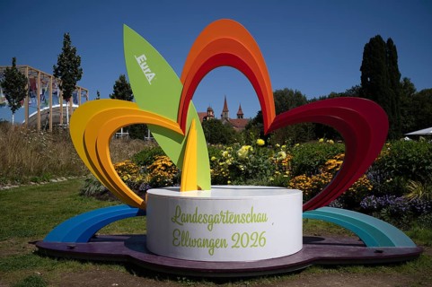 EurA AG logo on a symbol, a sculpture of a flower, with the Protestant Town Church and the