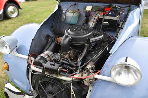 Close-up view of an open engine of a vintage blue car with visible technology, Citroen 2CV car