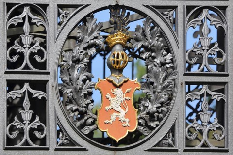 Coat of arms with lion figure and double tail, lattice helmet, crown, cast iron with decorations,