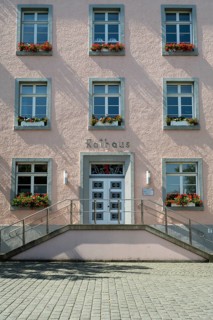 Façade of the town hall, flower boxes with geraniums in front of the windows, symmetry, Soest,