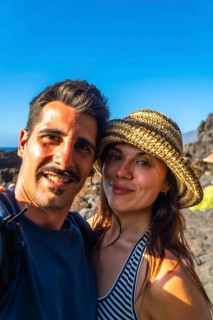 Happy couple taking a selfie together, smiling and enjoying their summer vacation at el hierro