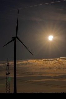 Wind power plant, high-voltage pylon, clouds, contrails, partial solar eclipse, Melbeck,