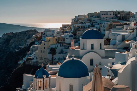 View of Mount Oia and the church with blue domes, Scenic view of Santorini with iconic blue-domed