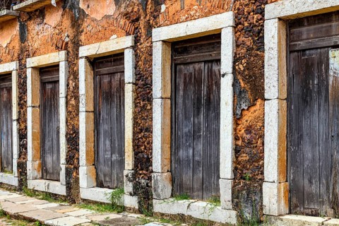Wooden doors with stone frames in a historic 17th-century building in the city of Sao Luis,