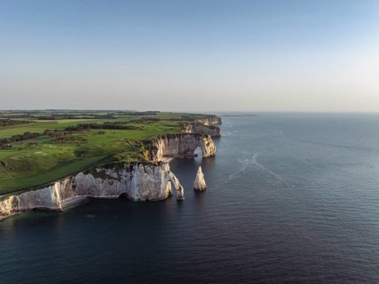 Aerial view of the Porte d'Aval rock formation in the evening sun, well-known sights on the chalk