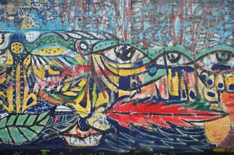 Colorful wall mural, graffiti with eye motifs and colorful, abstract shapes, Ecuador